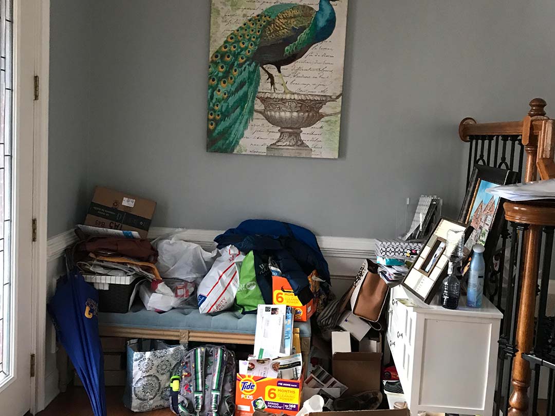 view of a hallway cluttered before professional organizing